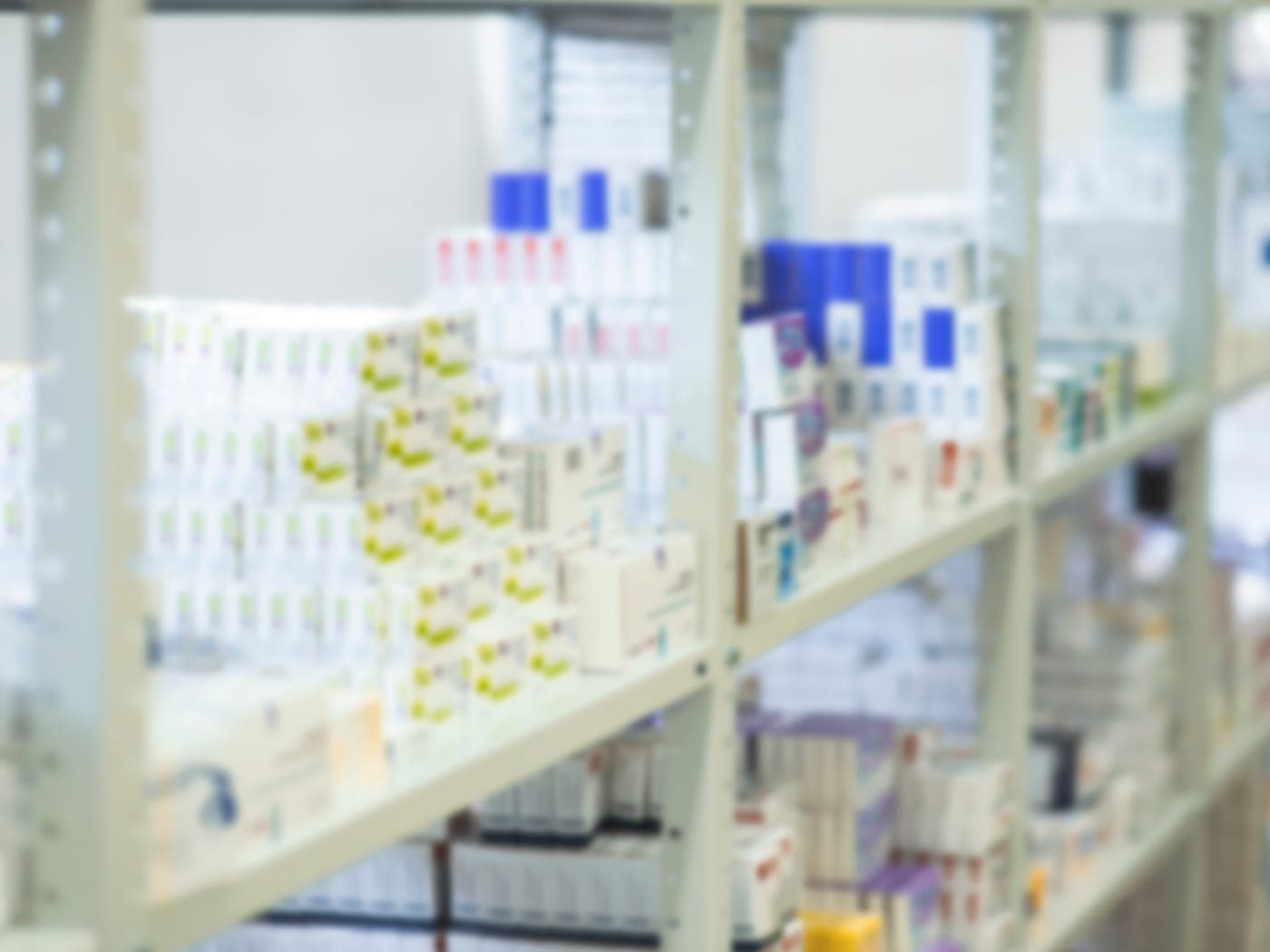 Shelves of clearly labelled medical supplies in a clinic store room.